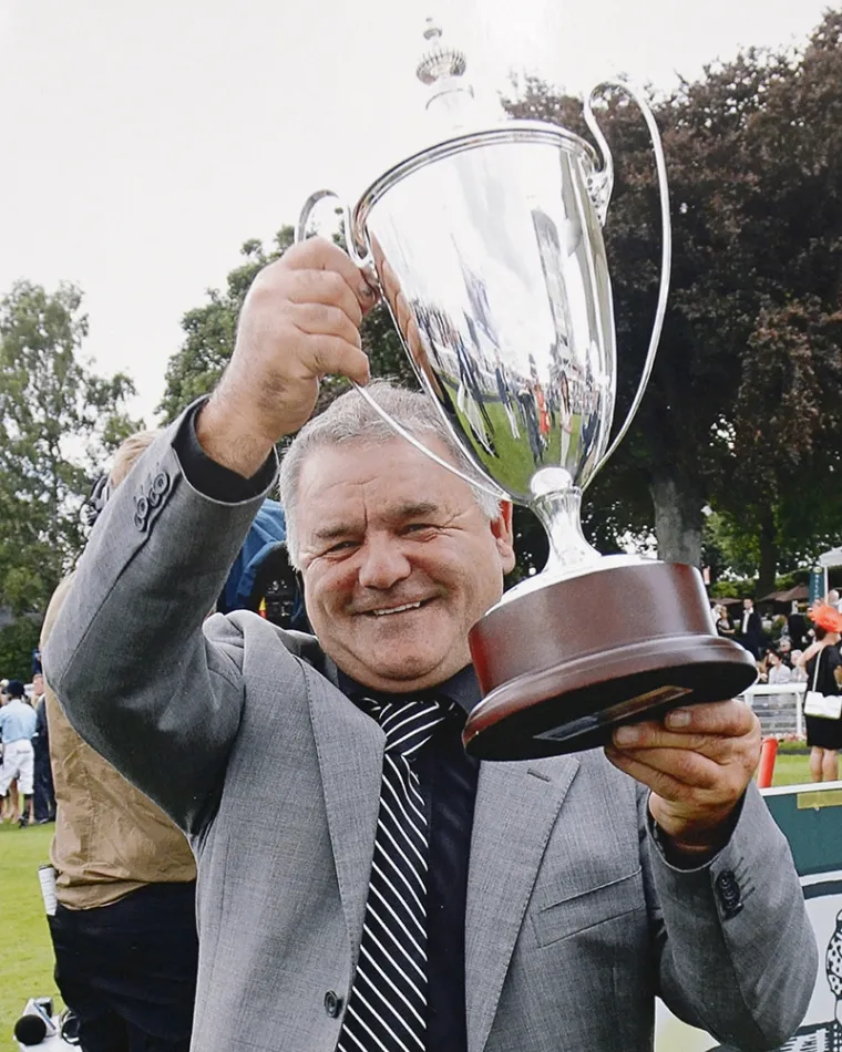 Brian Ellison holding a racecourse trophy